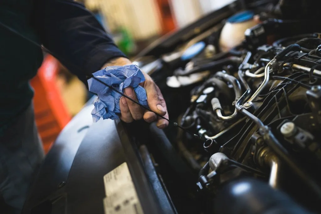 Technician performing a full synthetic oil change at Car Tune Up Sarasota, Florida