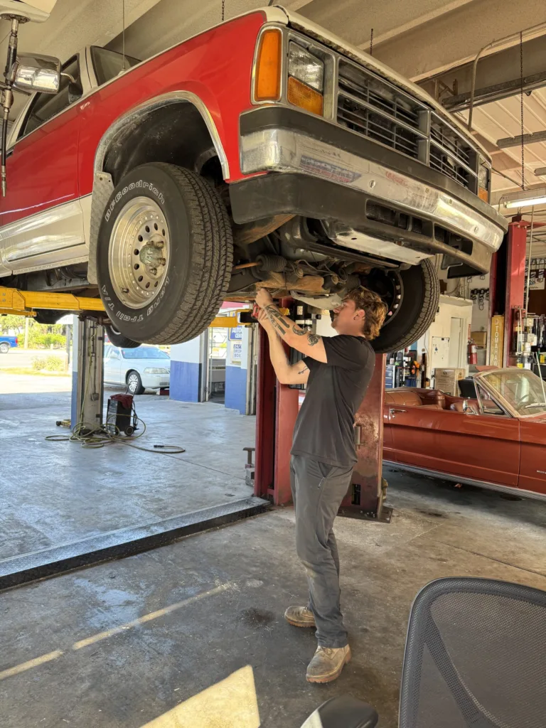 Trent working under a car oil change in sarasota fl. lube services. vehicle full service.