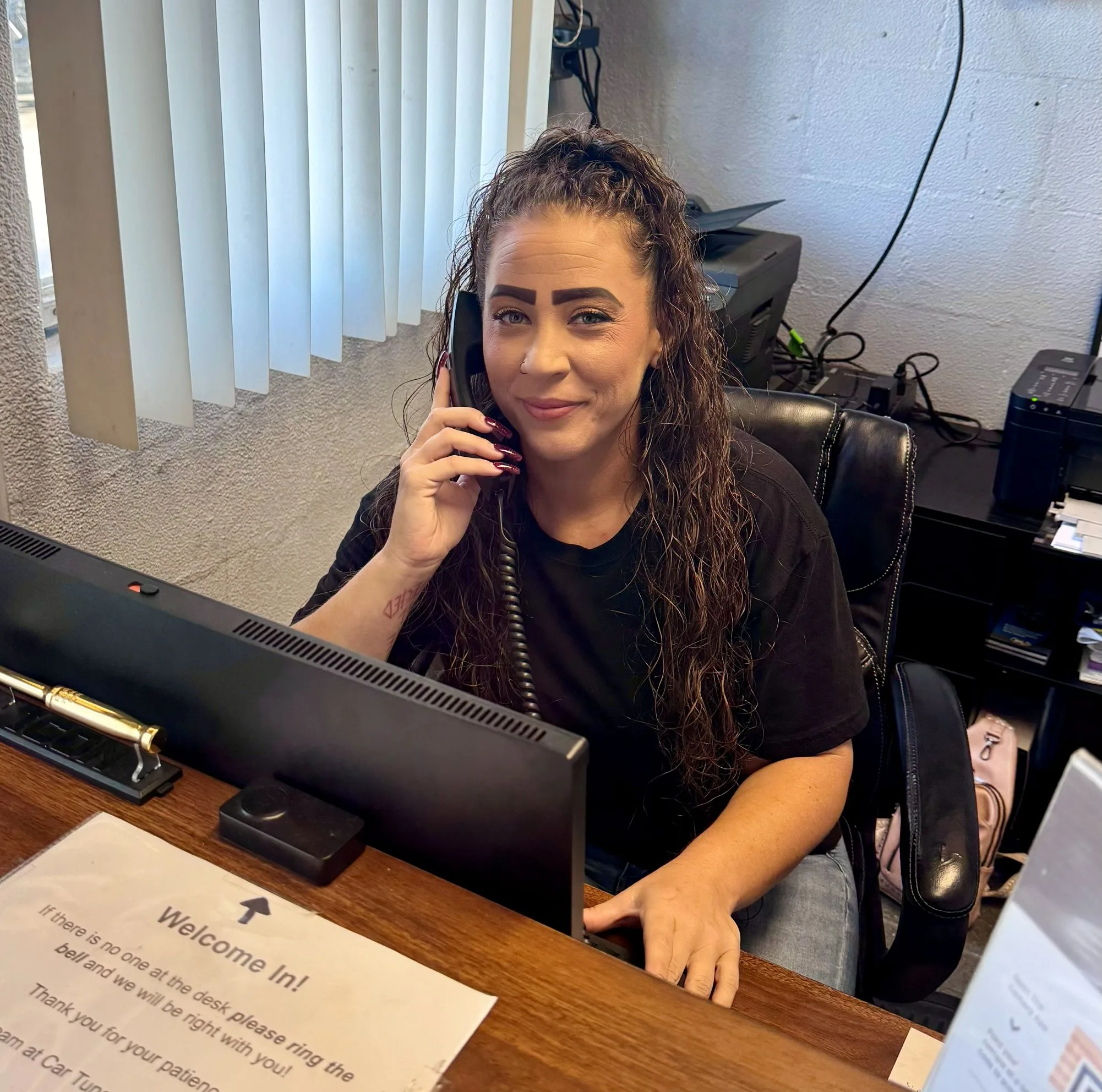 Christine Bowersox, Service Writer at Car Tune Up – Sarasota, assisting customers with auto repair scheduling and service updates inside the family-owned veteran-operated shop.