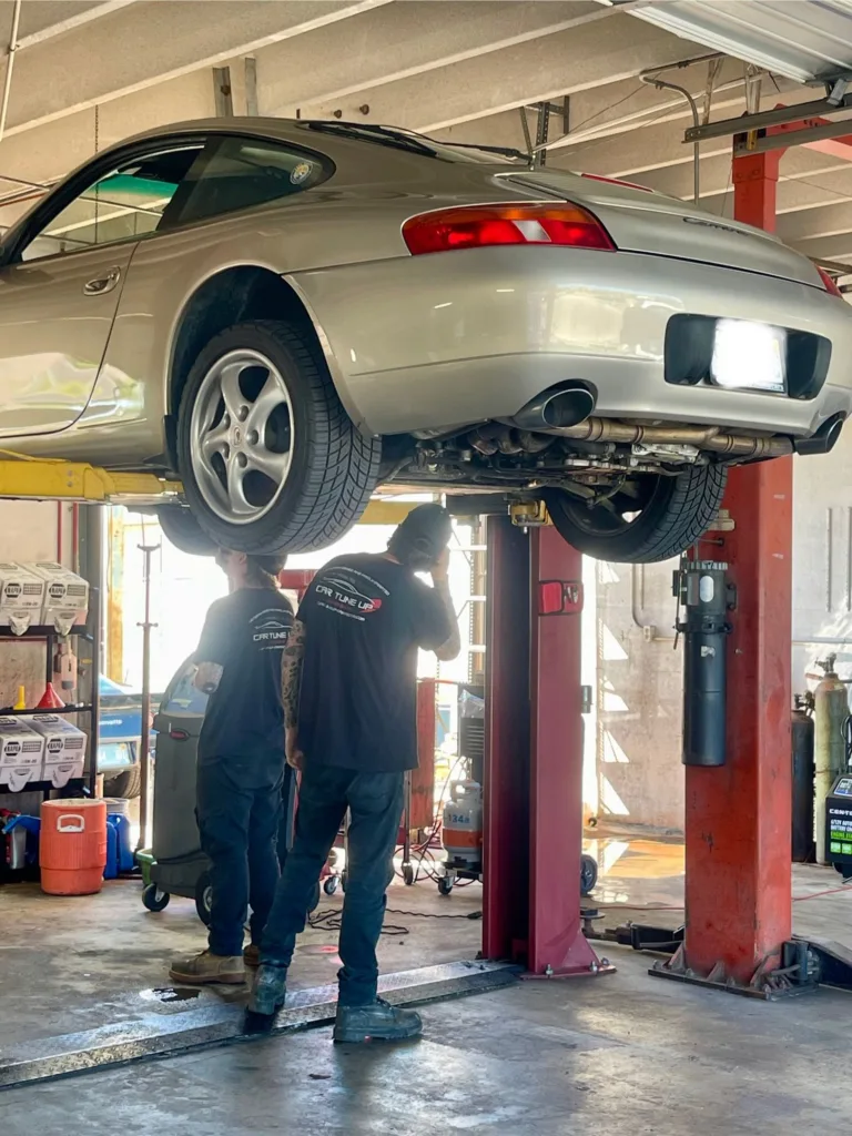 Car Tune Up – Sarasota street sign offering Free Multi-Point Inspection with Any Service — family-owned, veteran-operated auto repair shop serving Sarasota FL.
